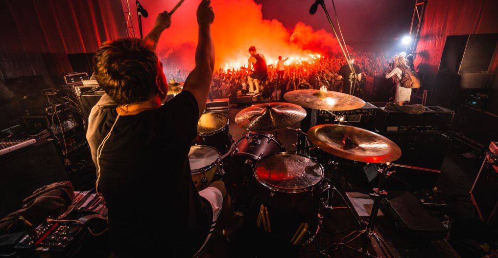 Drummer on stage. silhouette of music band in action on music st Drummer on stage. silhouette of music band in action on music stage. popular music rock band performs on stage.